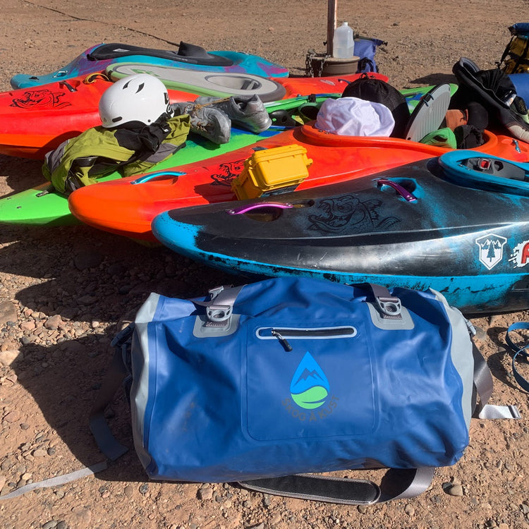 A blue Skog å Kust duffel bag being used on a whitewater kayak trip